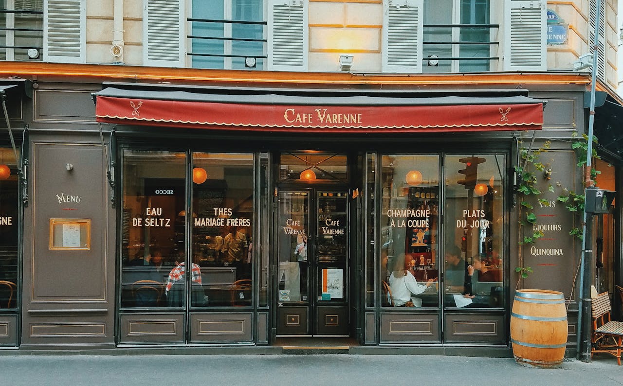 services-03 Parisian cafe storefront with classic architecture and red awning.