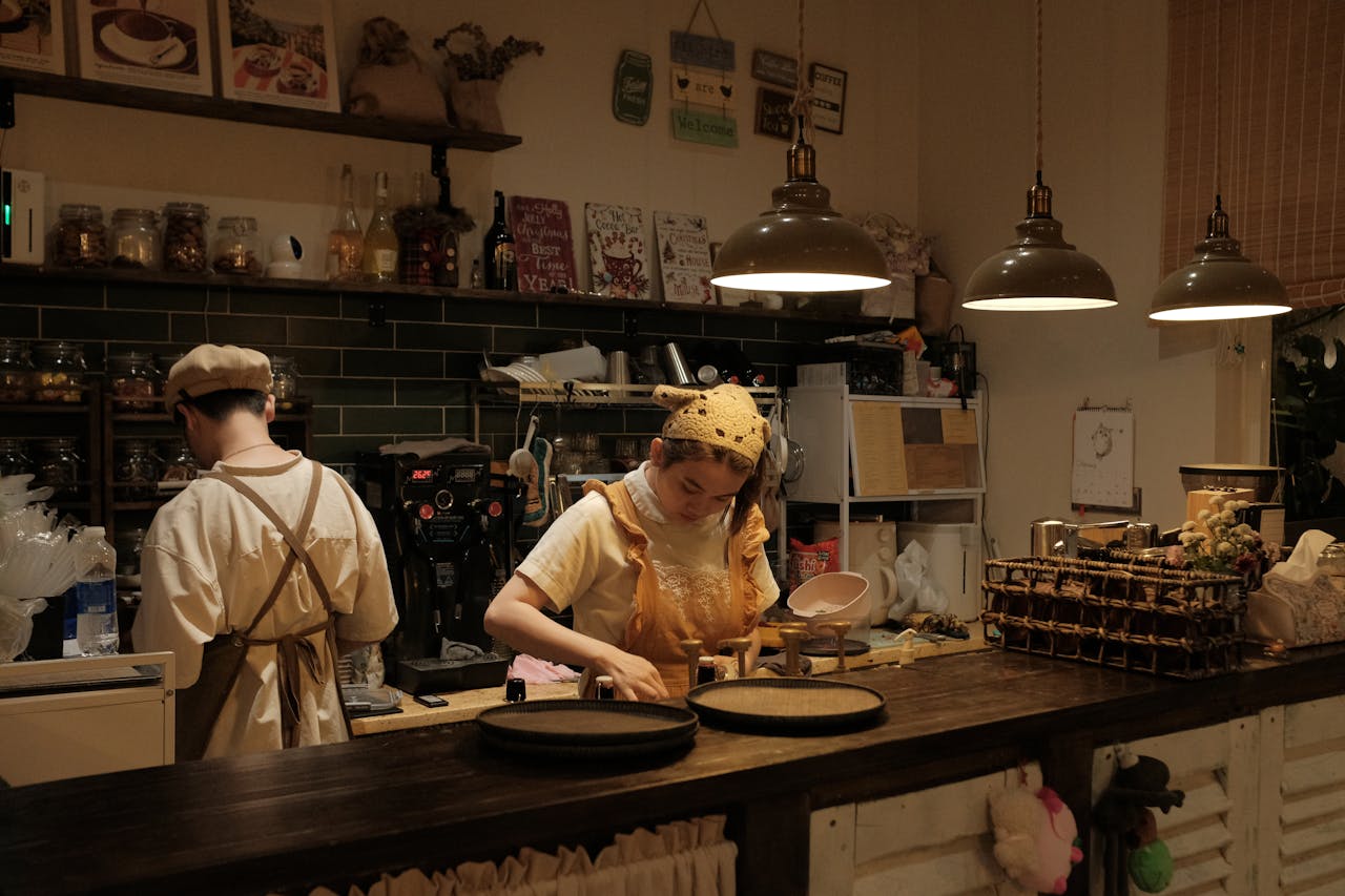 about-01 Vintage-style cafe in Bến Tre, Vietnam with baristas preparing coffee. Warm, inviting atmosphere.